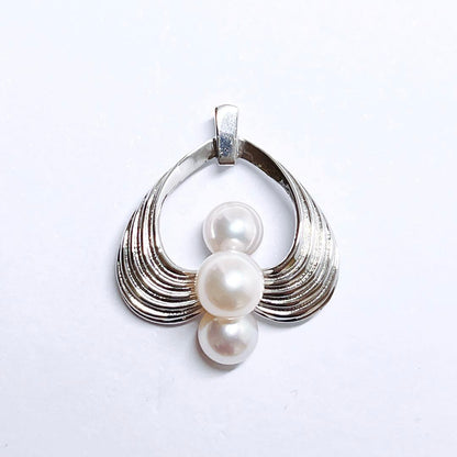 Mikimoto silver pearl necklace pendant top with 6.2-6.9mm round pearls on a white background