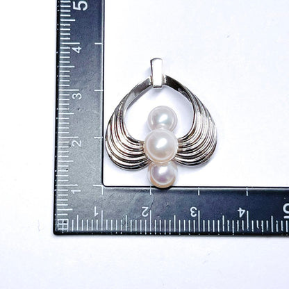Mikimoto silver pearl necklace pendant top with 6.2-6.9mm round pearls on a white background