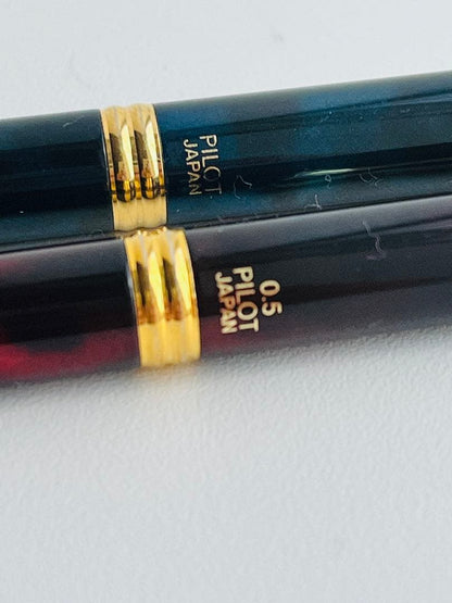 Set of two Pilot Cavalier first generation writing instruments mechanical pencil red marble and blue marble ballpoint pen