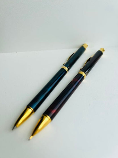 Set of two Pilot Cavalier first generation writing instruments mechanical pencil red marble and blue marble ballpoint pen