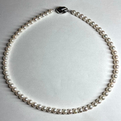 Aurora Interference color Akoya pearl necklace with 6.0-6.5mm white pearls and silver clasp on a white background