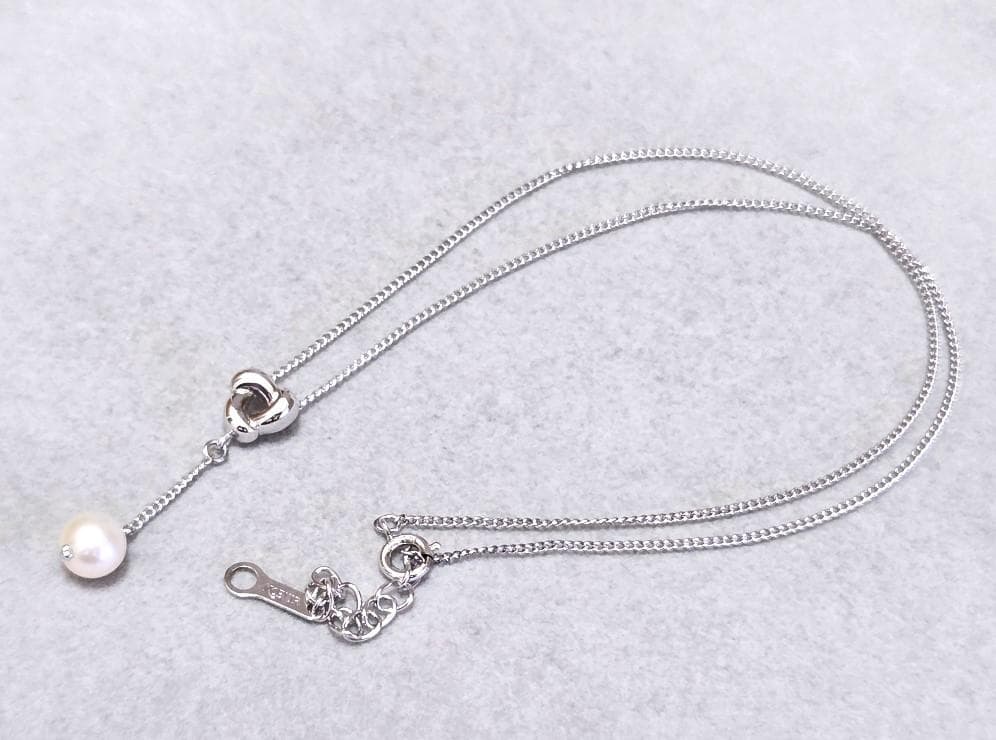 Tasaki Akoya pearl necklace in silver with 42.5cm length displayed with its box