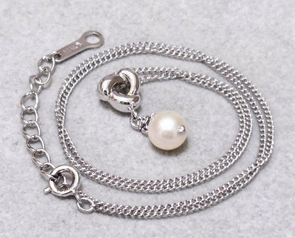 Tasaki Akoya pearl necklace in silver with 42.5cm length displayed with its box