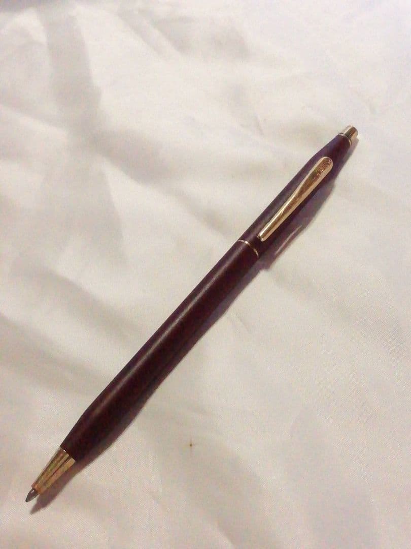 CROSS slim ballpoint pen in chic wine red color writing on paper