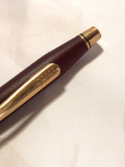 CROSS slim ballpoint pen in chic wine red color writing on paper