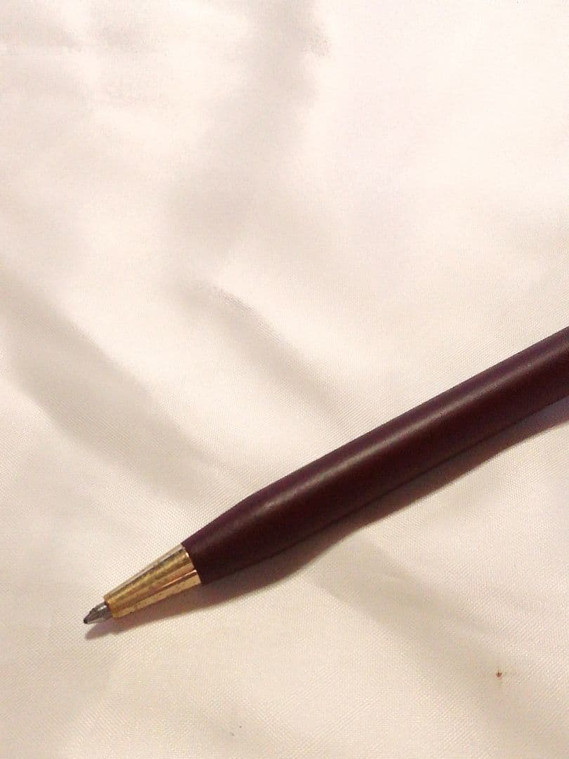 CROSS slim ballpoint pen in chic wine red color writing on paper