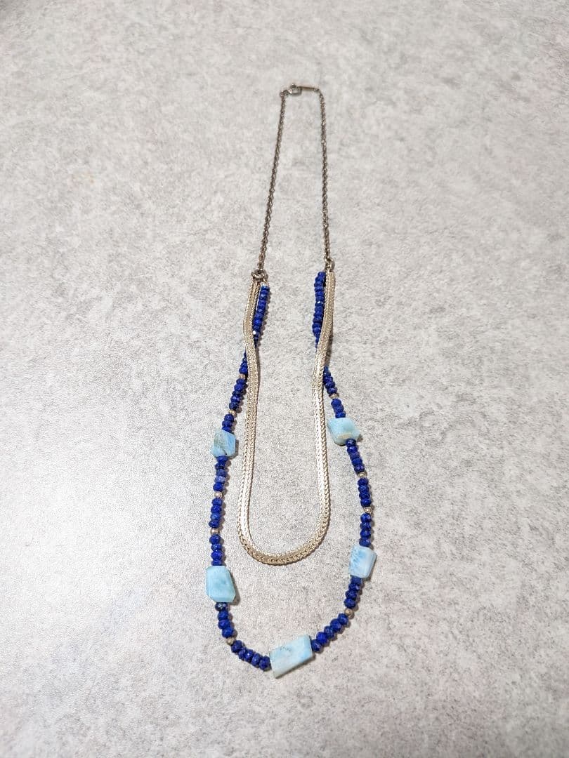 Agete silver double necklace with blue beads featuring a two-strand design, displayed on a white background