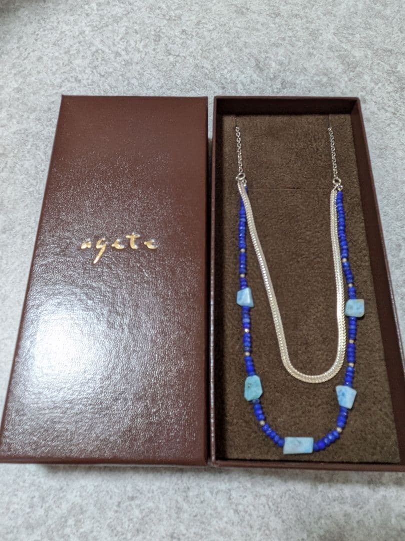 Agete silver double necklace with blue beads featuring a two-strand design, displayed on a white background
