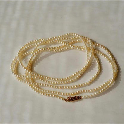 Freshwater Akoya baby pearl necklace 112cm long with small ivory tone pearls and gold plated fittings