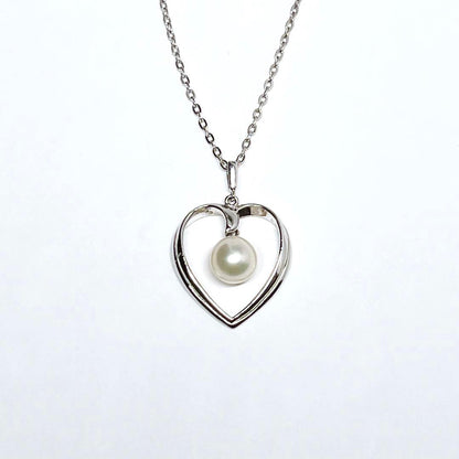 Mikimoto pearl necklace with heart motif featuring 7.1mm pearls on silver chain at 40cm length