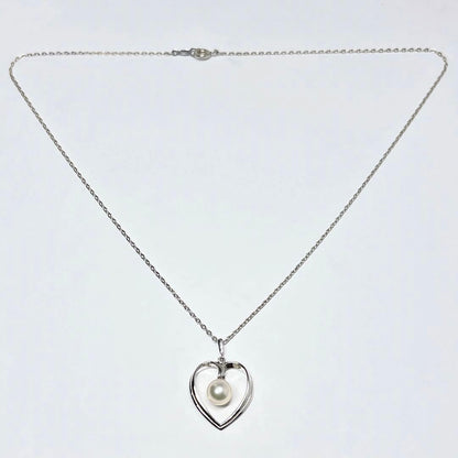 Mikimoto pearl necklace with heart motif featuring 7.1mm pearls on silver chain at 40cm length