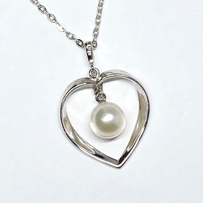 Mikimoto pearl necklace with heart motif featuring 7.1mm pearls on silver chain at 40cm length