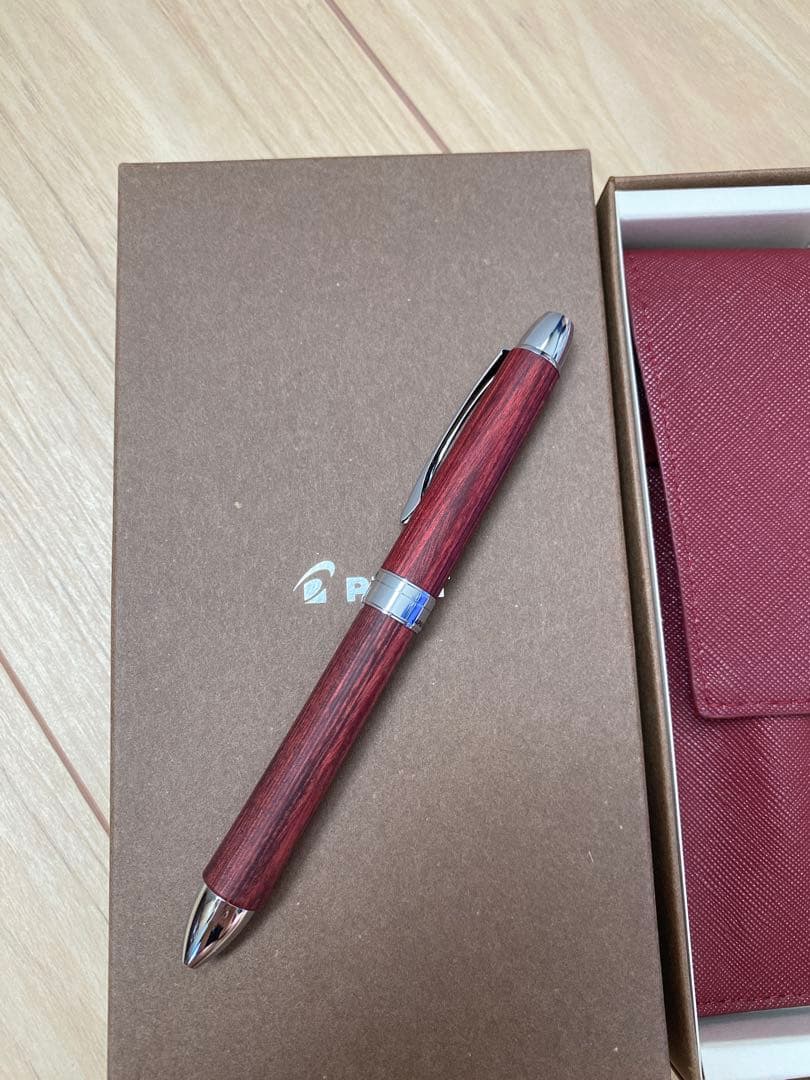 Pilot 3-color ballpoint pen showing red, blue, and black ink with included pen case