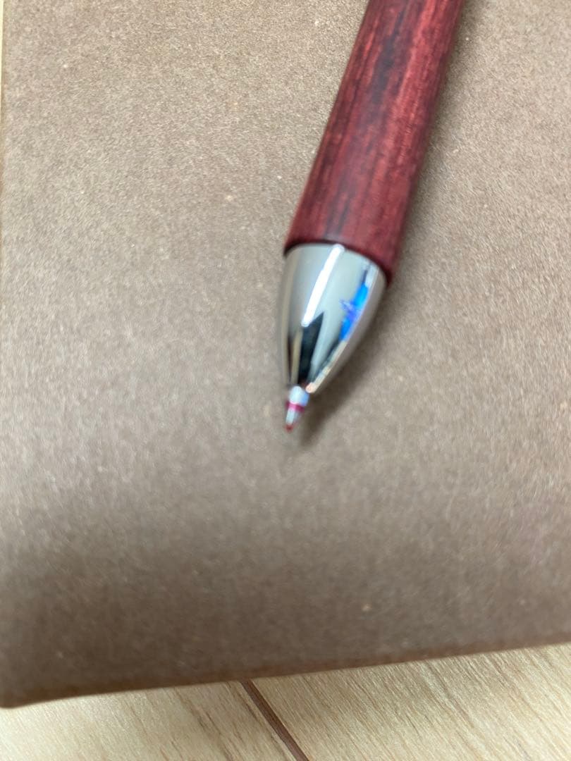 Pilot 3-color ballpoint pen showing red, blue, and black ink with included pen case