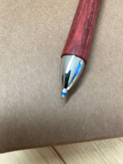Pilot 3-color ballpoint pen showing red, blue, and black ink with included pen case