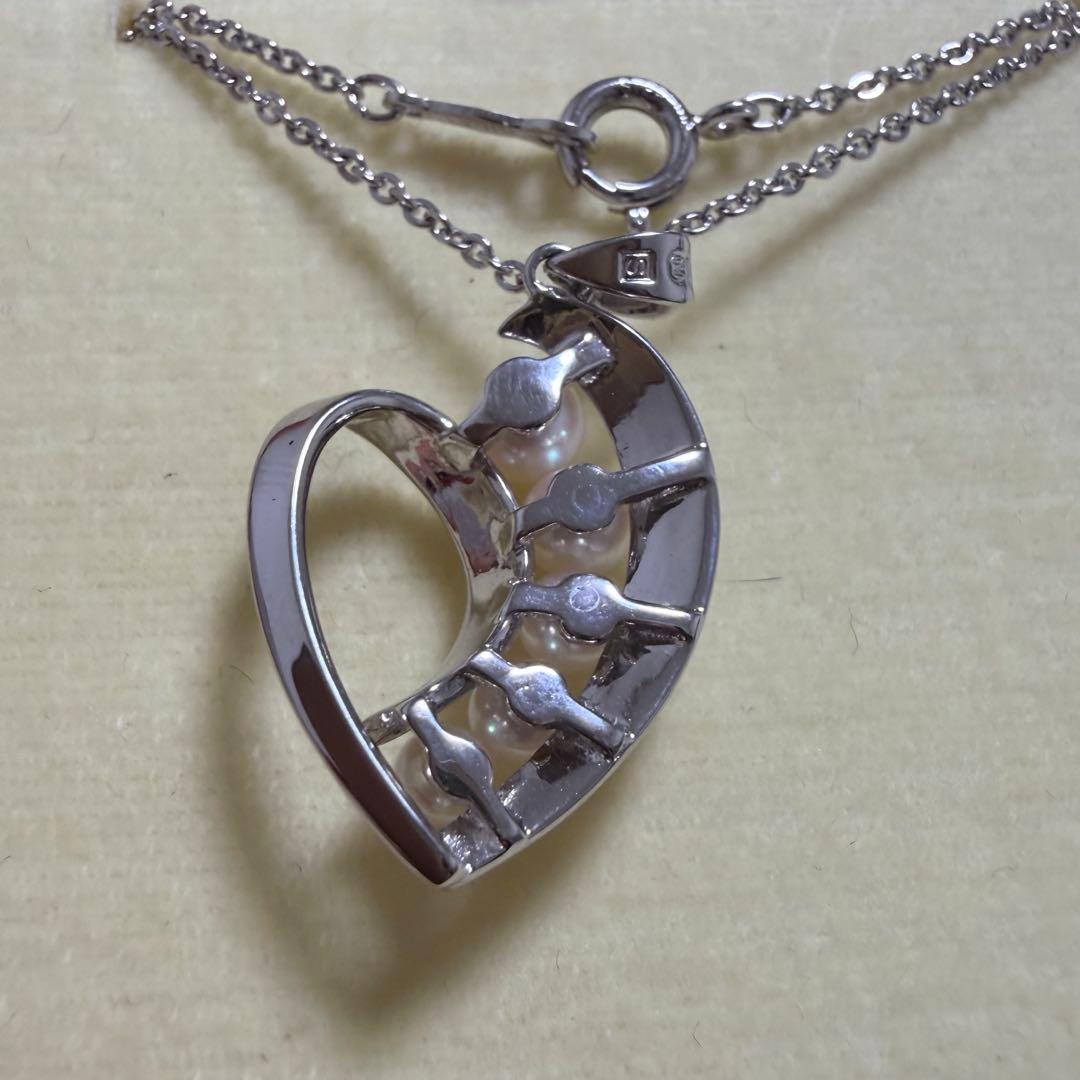 Mikimoto heart-shaped pearl pendant necklace featuring five pearls with silver decoration and included box
