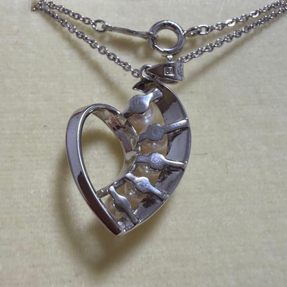 Mikimoto heart-shaped pearl pendant necklace featuring five pearls with silver decoration and included box
