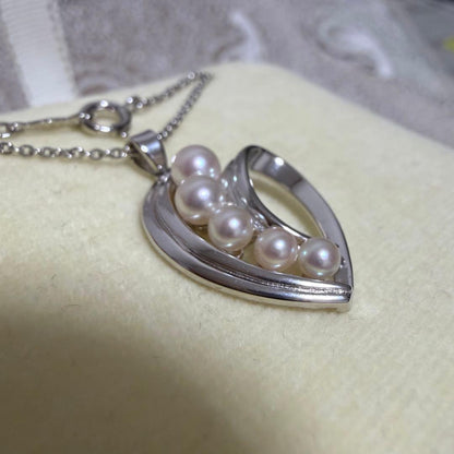 Mikimoto heart-shaped pearl pendant necklace featuring five pearls with silver decoration and included box