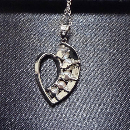 Mikimoto heart-shaped pearl pendant necklace featuring five pearls with silver decoration and included box