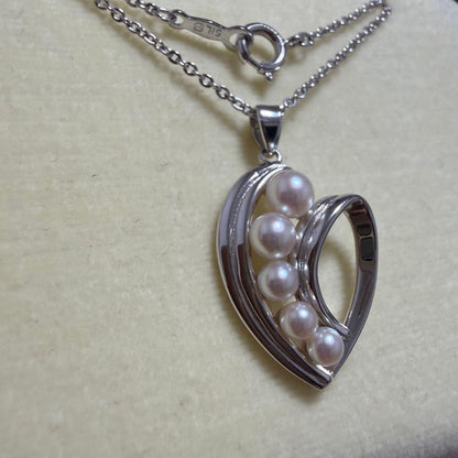 Mikimoto heart-shaped pearl pendant necklace featuring five pearls with silver decoration and included box