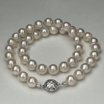 Akoya pearl necklace with 9.0-9.5mm white semi-round pearls and silver engraved round clasp, 42cm length