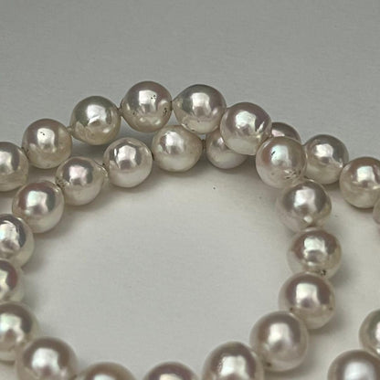 Akoya pearl necklace with 9.0-9.5mm white semi-round pearls and silver engraved round clasp, 42cm length