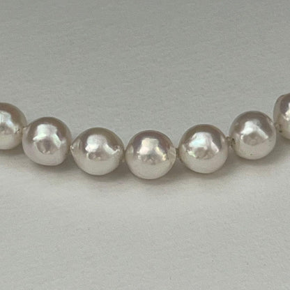Akoya pearl necklace with 9.0-9.5mm white semi-round pearls and silver engraved round clasp, 42cm length