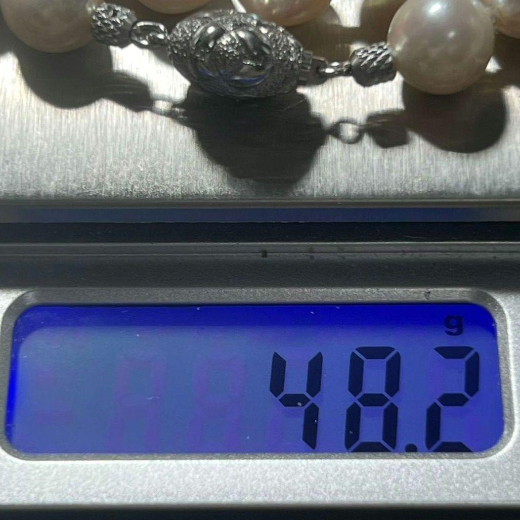 Akoya pearl necklace with 9.0-9.5mm white semi-round pearls and silver engraved round clasp, 42cm length