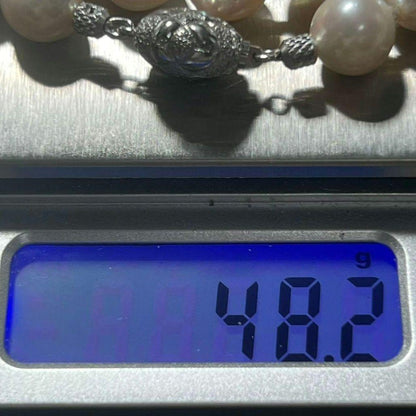 Akoya pearl necklace with 9.0-9.5mm white semi-round pearls and silver engraved round clasp, 42cm length