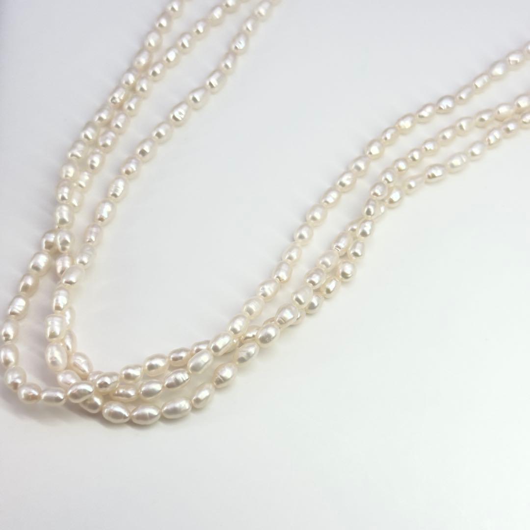 Tasaki SV Baroque Pearl triple strand necklace approximately 55cm long displayed on white background