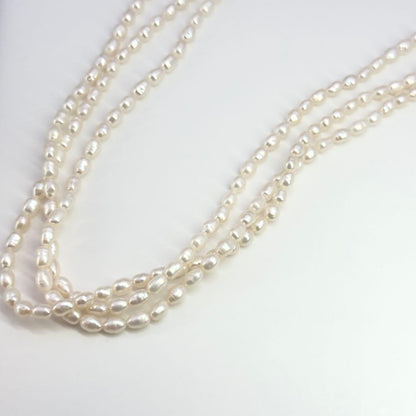 Tasaki SV Baroque Pearl triple strand necklace approximately 55cm long displayed on white background