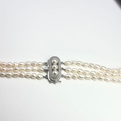 Tasaki SV Baroque Pearl triple strand necklace approximately 55cm long displayed on white background