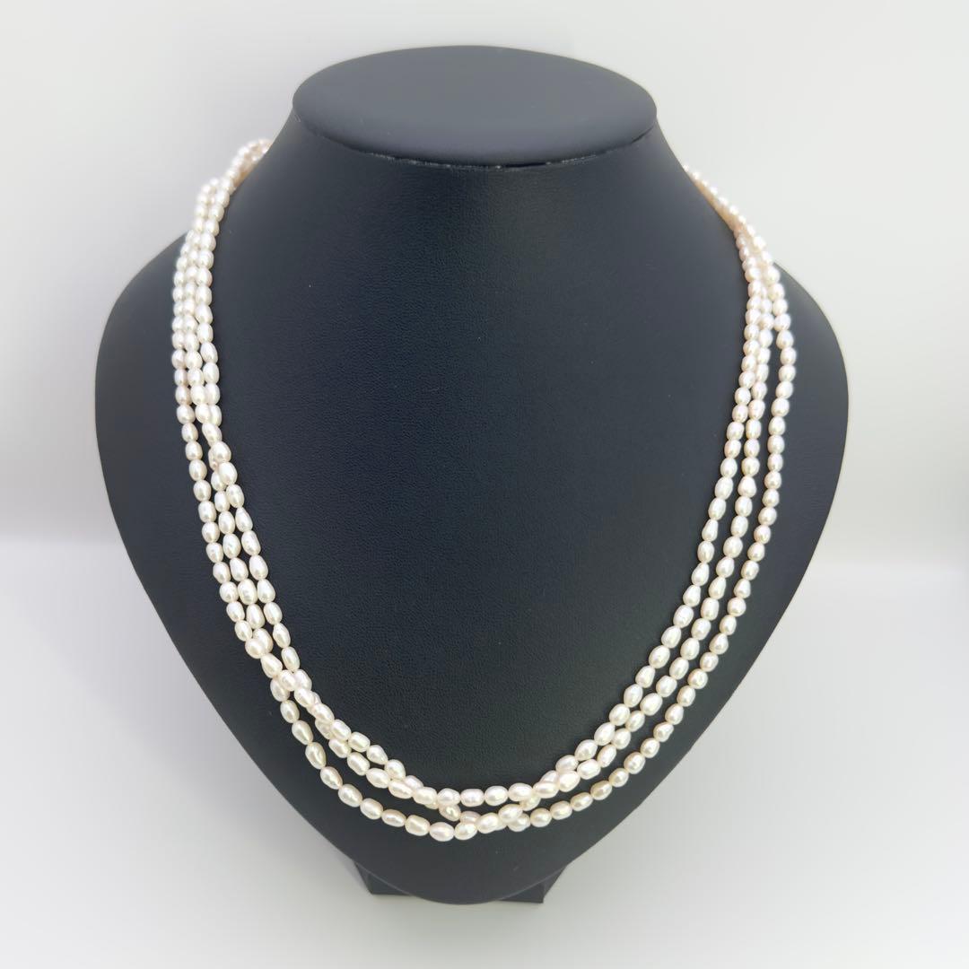 Tasaki SV Baroque Pearl triple strand necklace approximately 55cm long displayed on white background
