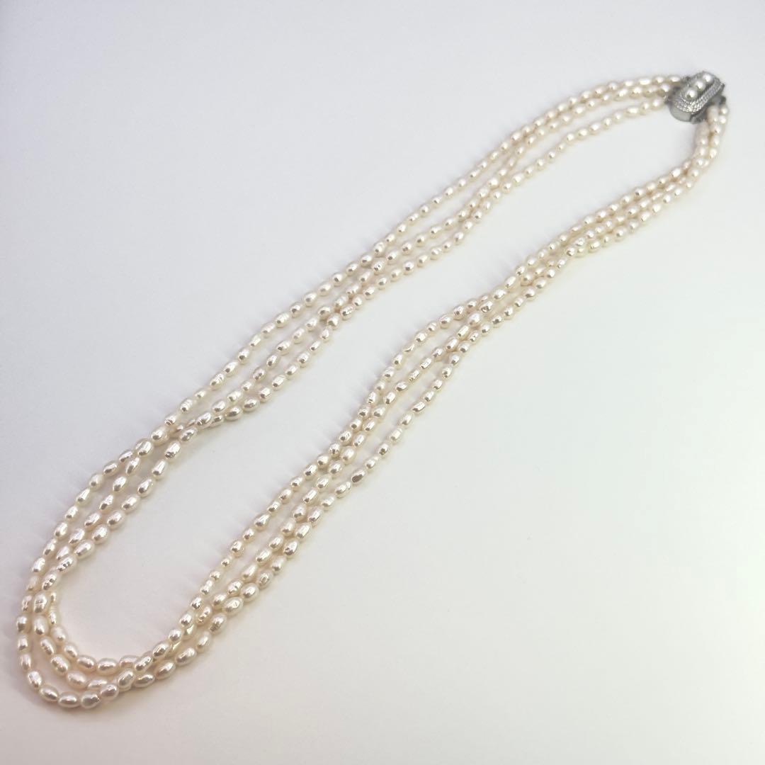 Tasaki SV Baroque Pearl triple strand necklace approximately 55cm long displayed on white background