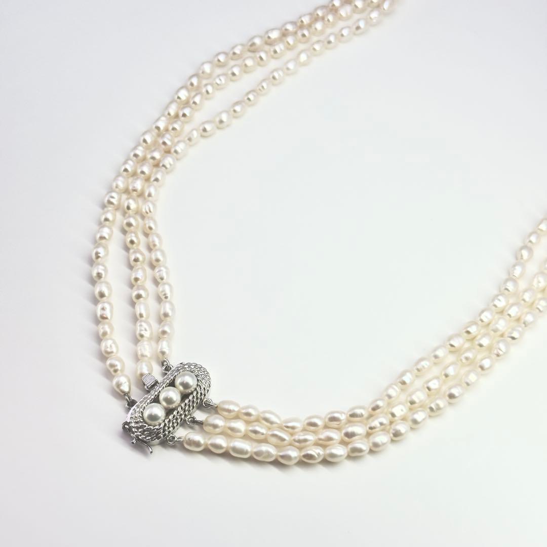 Tasaki SV Baroque Pearl triple strand necklace approximately 55cm long displayed on white background