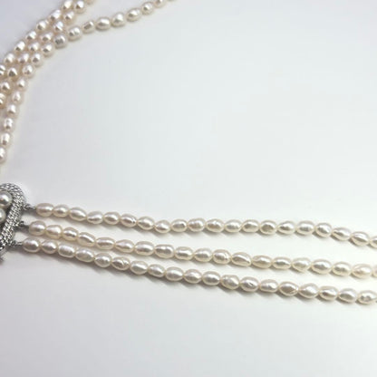 Tasaki SV Baroque Pearl triple strand necklace approximately 55cm long displayed on white background