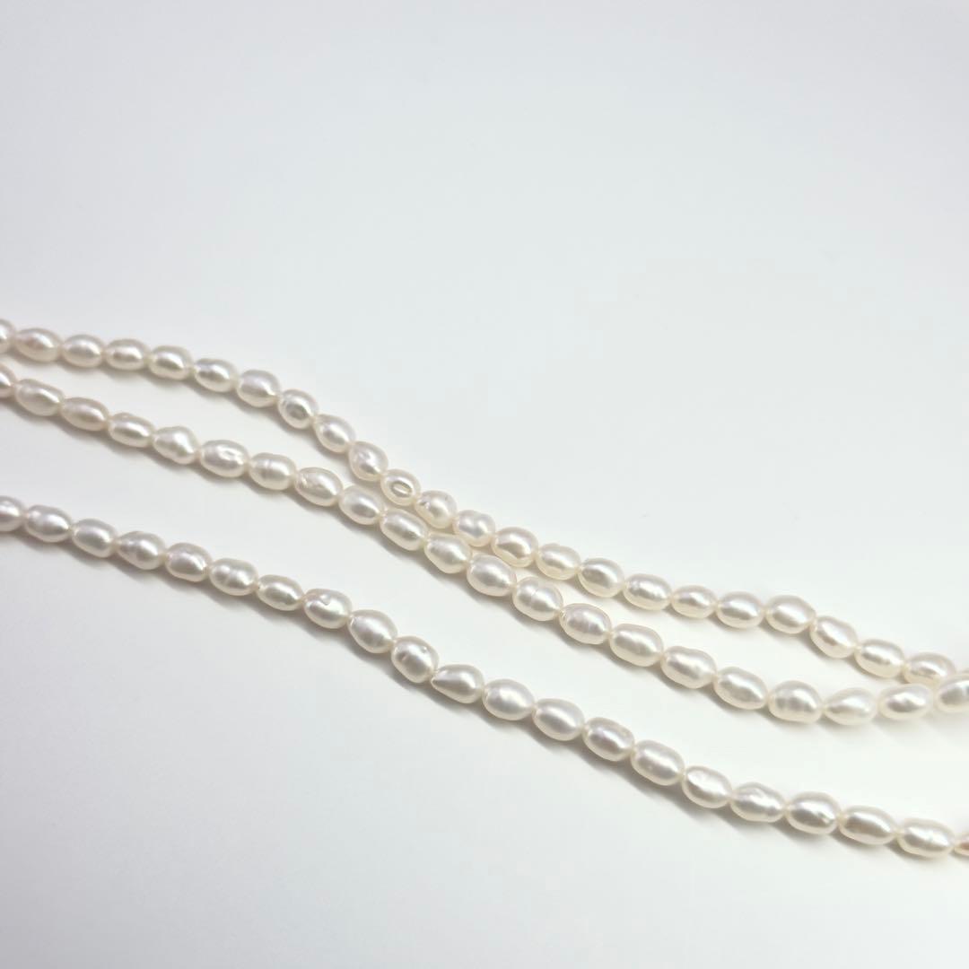 Tasaki SV Baroque Pearl triple strand necklace approximately 55cm long displayed on white background