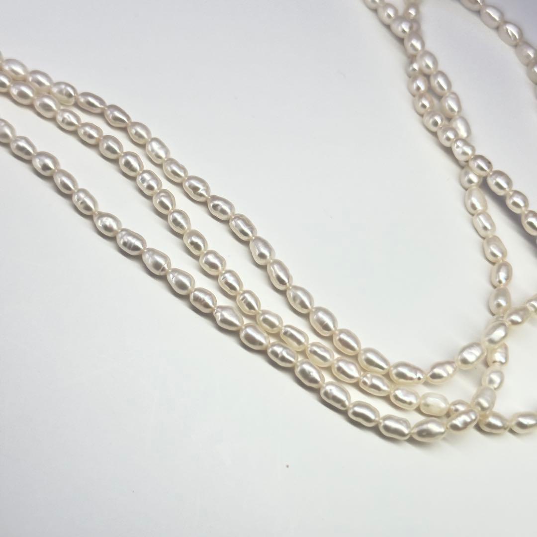 Tasaki SV Baroque Pearl triple strand necklace approximately 55cm long displayed on white background