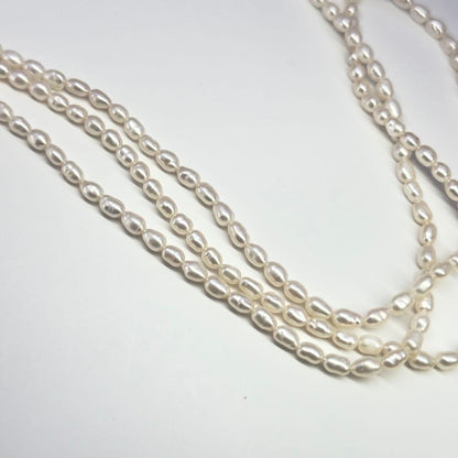 Tasaki SV Baroque Pearl triple strand necklace approximately 55cm long displayed on white background