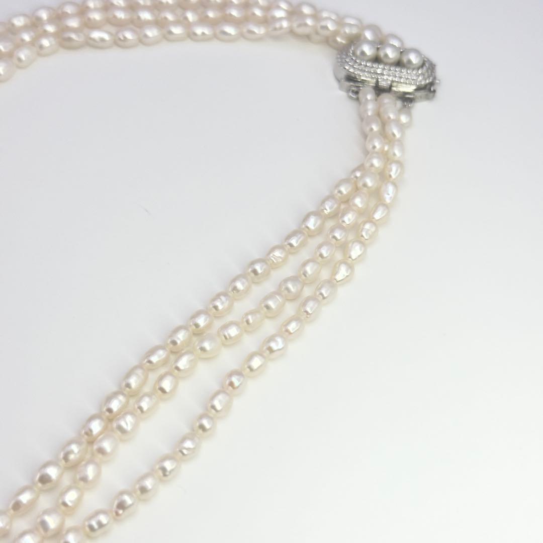 Tasaki SV Baroque Pearl triple strand necklace approximately 55cm long displayed on white background