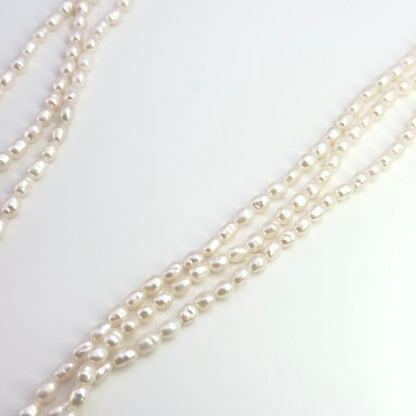Tasaki SV Baroque Pearl triple strand necklace approximately 55cm long displayed on white background