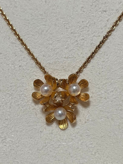 Mikimoto K18 gold baby pearl necklace with 3-row flower motif design weighing 4.5 grams