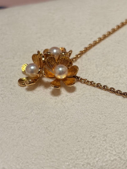 Mikimoto K18 gold baby pearl necklace with 3-row flower motif design weighing 4.5 grams