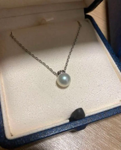 Close-up of Mikimoto elegant pearl necklace with 7-8mm white pearls strung on a delicate chain