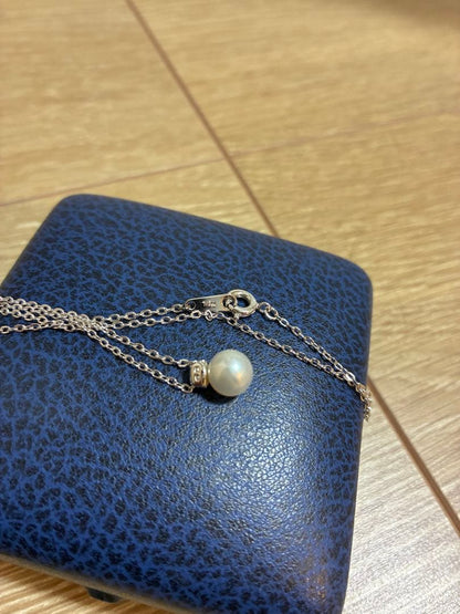 Close-up of Mikimoto elegant pearl necklace with 7-8mm white pearls strung on a delicate chain