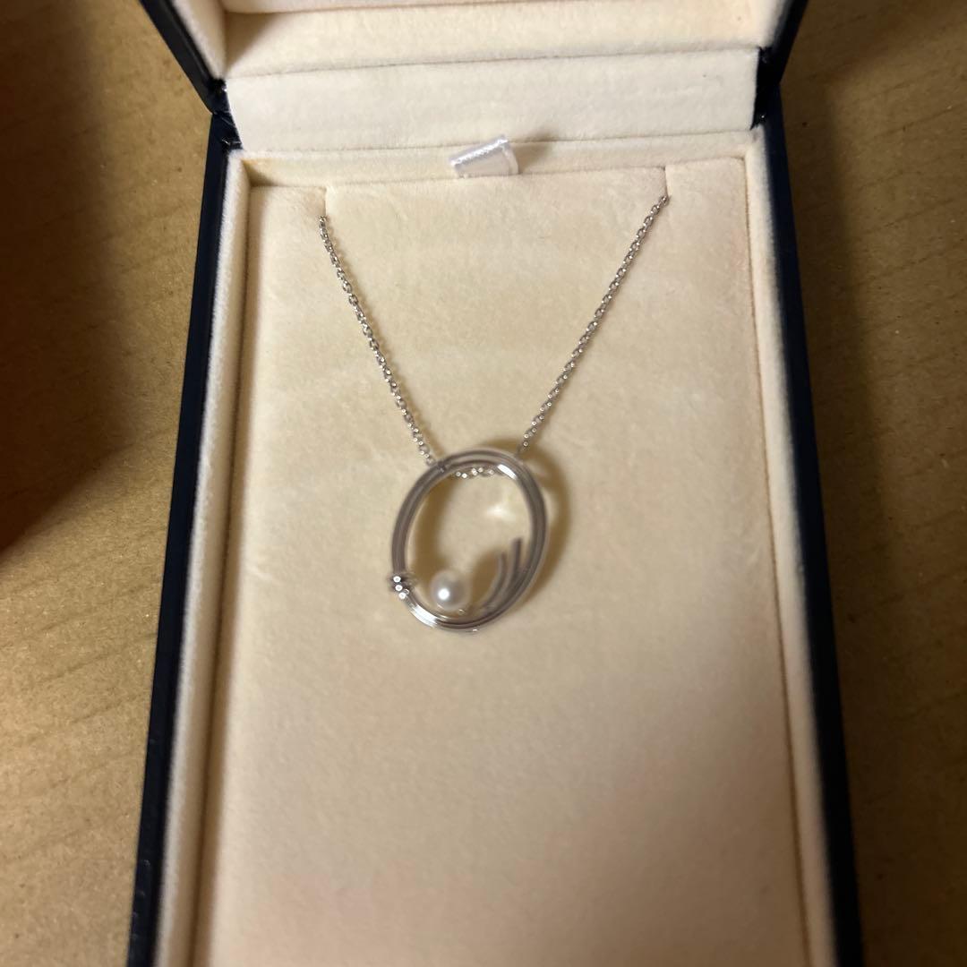 TASAKI silver necklace with oval pearl pendant displayed on white background with dedicated box