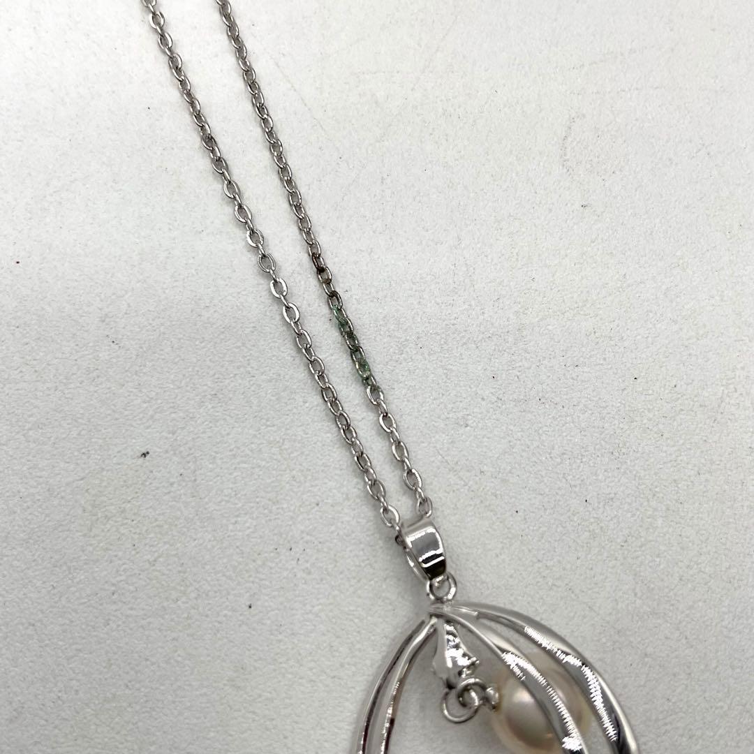 Mikimoto pearl necklace in silver with detailed clasp and round pearls displayed