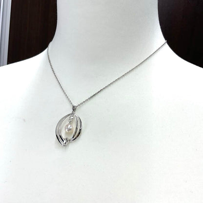 Mikimoto pearl necklace in silver with detailed clasp and round pearls displayed