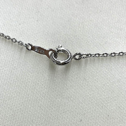 Mikimoto pearl necklace in silver with detailed clasp and round pearls displayed