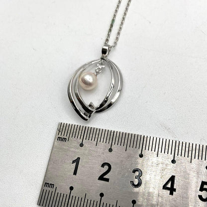Mikimoto pearl necklace in silver with detailed clasp and round pearls displayed